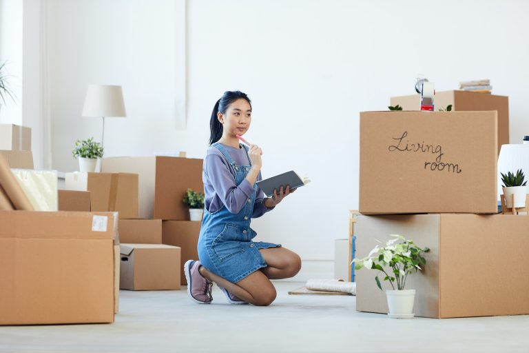 Young Asian Woman Organizing Boxes